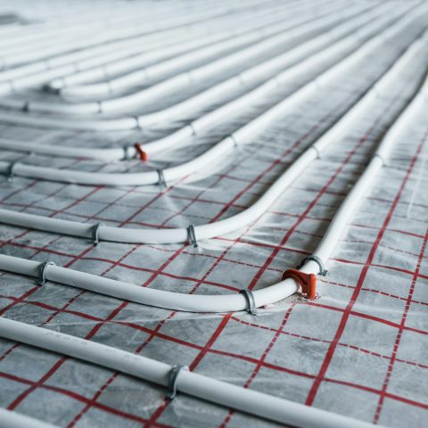 Pipes of underfloor heating system. Close up view. No people